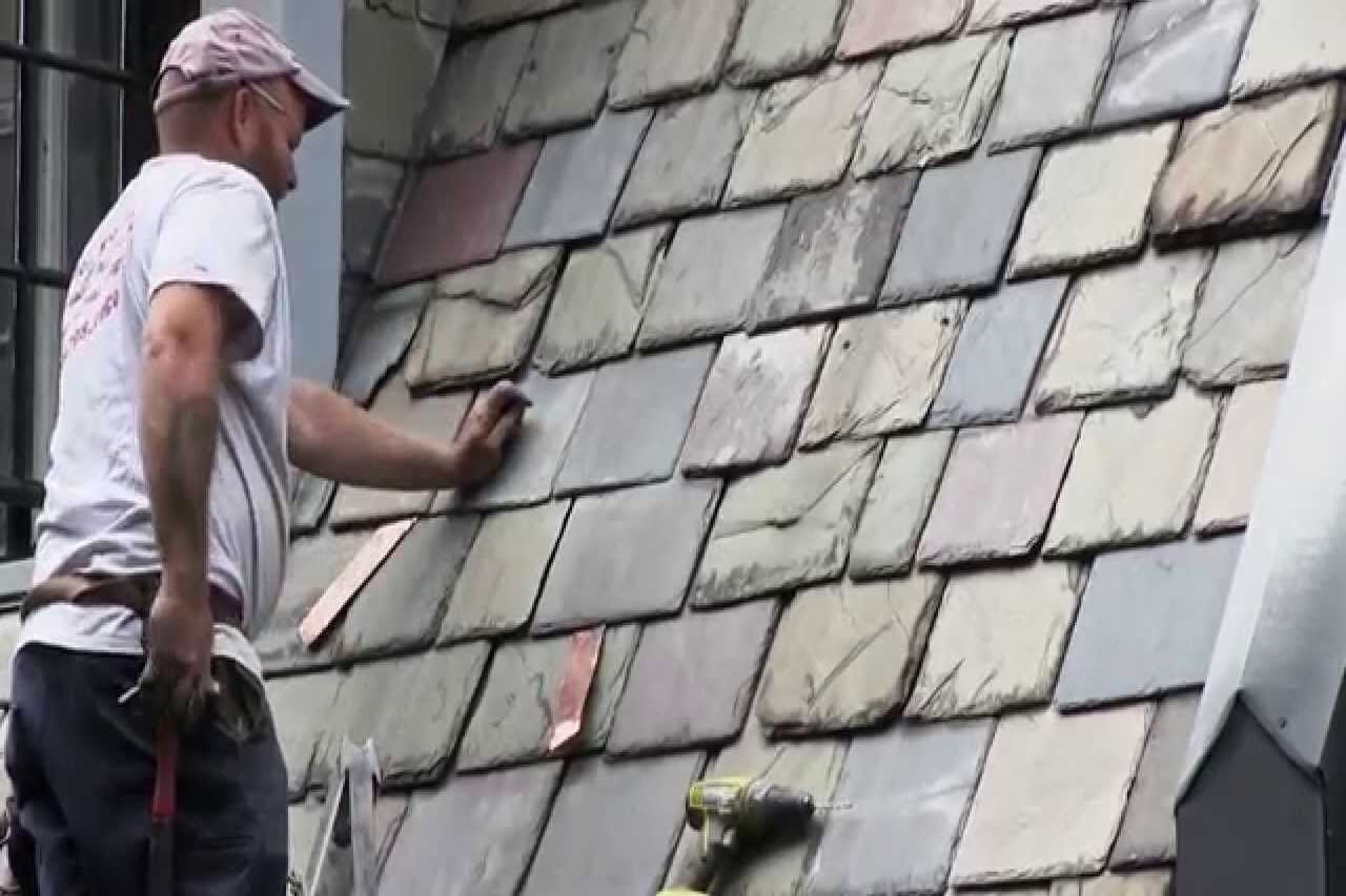 roofer repairing a slate roof on West Penn Street East Falls Pa